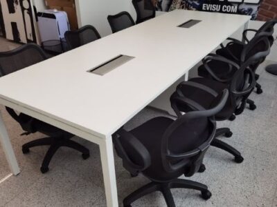 White office table with black office chairs in office space