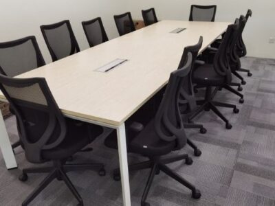 Conference table with black chairs in office space_Offitek