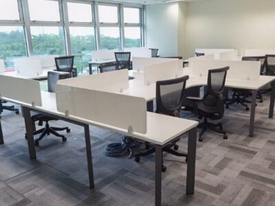 White workstation with white desktop panel and black office chairs in office space