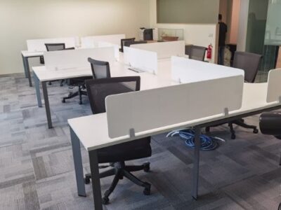 White workstation with white desktop panel in office space